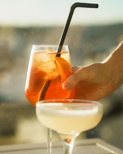 a person holding a drink in a glass at Hotel Estepona Plaza in Estepona