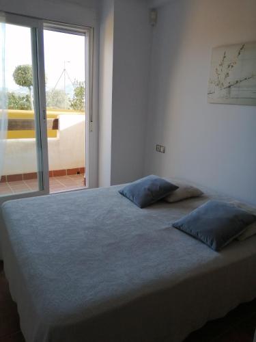 a bedroom with a bed with two pillows on it at Lomas del mar V in Vera