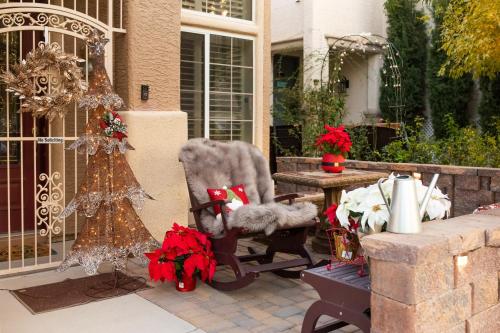 a porch with a rocking chair and a christmas tree at Private Yard Las Vegas Sanctuary on Cul-De-Sac in Las Vegas