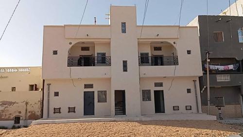 a building with two balconies on the side of it at socogimps in Nouakchott
