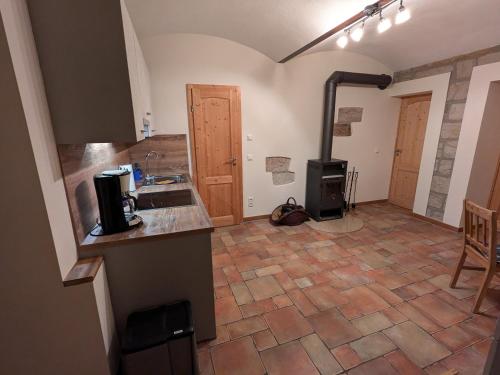 a kitchen with a counter and a stove in a room at Ferienwohnung "WILLI" in Hohnstein