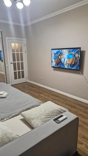 a bedroom with a bed and a painting on the wall at AIRPORT-TAXI-PARKING-Card in Chişinău