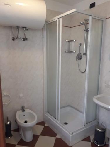a bathroom with a shower and a toilet and a sink at Giada in Moneglia