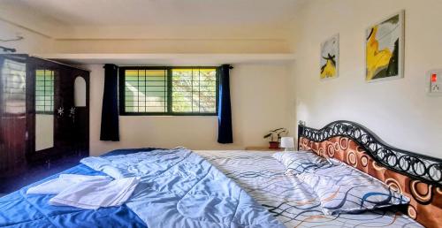 a bedroom with a large bed with blue sheets at Your perfect high standart cosy Home near Arambol with 2BHK in Arambol