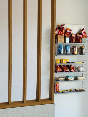 ajar view of a closet with a shelving unit with at Haus am Wasserturm Gästezimmer in Schorndorf-Schlichten in Schorndorf