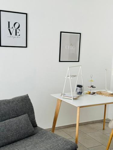 a living room with a chair and a table at Haus am Wasserturm Gästezimmer in Schorndorf-Schlichten in Schorndorf