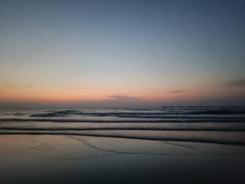 a view of the ocean at sunset at Shantadurga Beachside Homestay in Guhagar