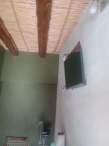 a room with a tv on the ceiling of a room at Ipay Alojamiento Familiar in Purmamarca