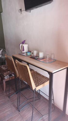 a table with two chairs and a counter top at Ipay Alojamiento Familiar in Purmamarca