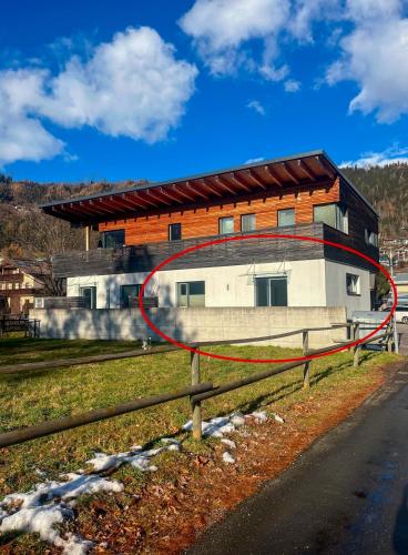 a building with a red circle in front of it at Bestezeit Appartements in Schladming