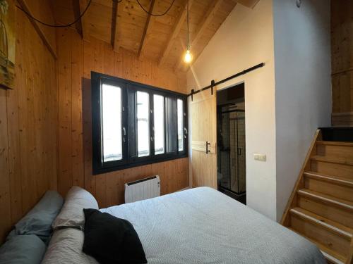 a bedroom with a bed and a window at Casa Arroio - Casco antiguo de Allariz in Allariz