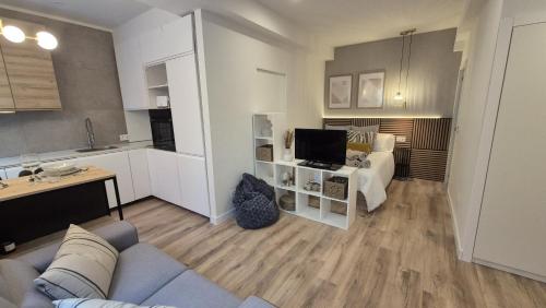 a living room with a couch and a tv at 5 Dragos Suites in La Orotava