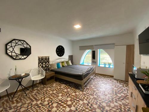 a bedroom with a bed and a table and chairs at JANUS COUNTRY SITE Árpád-ház in Szakcs
