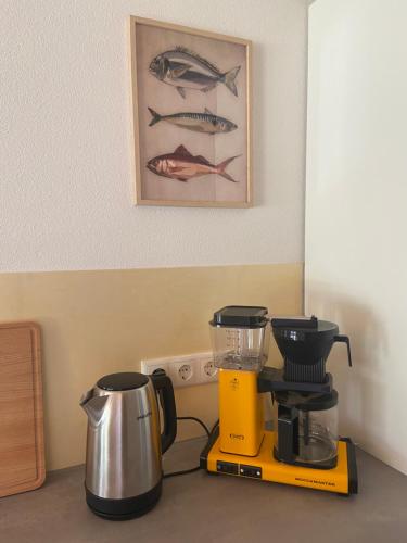 a kitchen counter with a blender and a coffee maker at Haus 7&50 in Bolsterlang