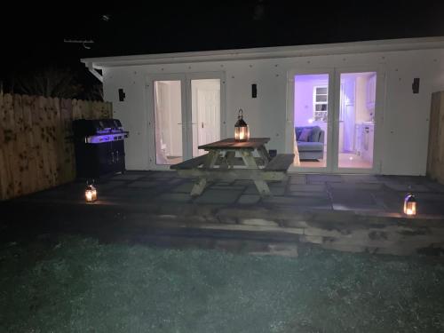 a picnic table in the middle of a patio at night at The Burren Snug in Galway