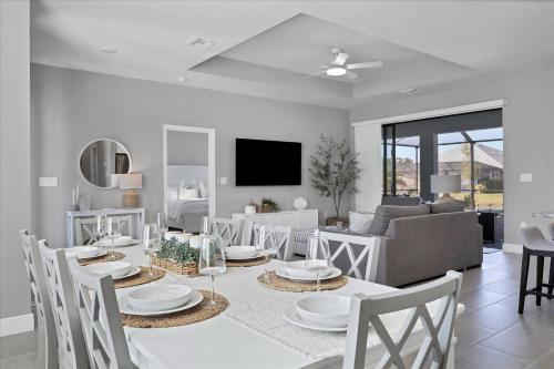 a dining room and living room with a table and chairs at 25499 Doredo in Burnt Store Marina