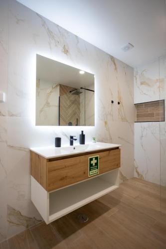 a bathroom with a sink and a mirror at Casa da Colina in Ferragudo