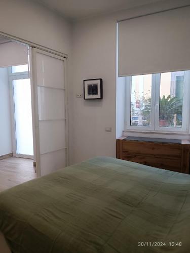 a bedroom with a large bed and two windows at Villanova 48 in Naples