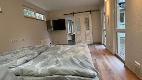 a large bed in a bedroom with a large window at Klimaanlage, 5 Sterne Villa Bahnhoftraum, plus NEU zubuchbares Event, 333 qm, 1200qm Garten, virtueller Rundgang, Dachterrasse, Whirlpoolbadewanne in Braunfels