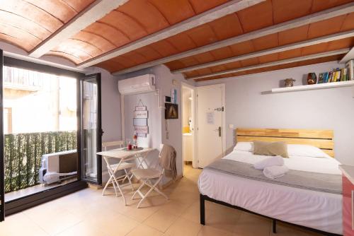 a bedroom with a bed and a table at Trinquet by Unik Vacation in Tarragona
