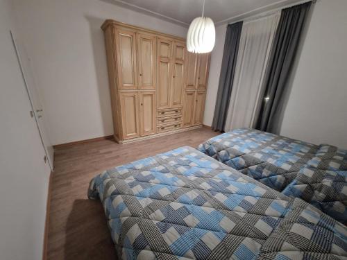 a bedroom with a bed and a wooden cabinet at Appartamento Moka in Pontassieve