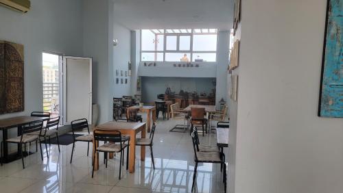 a dining room with tables and chairs in a building at Apartment 6, Turquaz residence in Accra