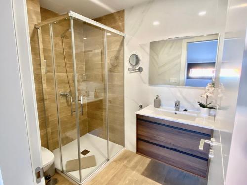 a bathroom with a shower and a sink at Luxury penthouse with pool near Fuengirola beach in Fuengirola