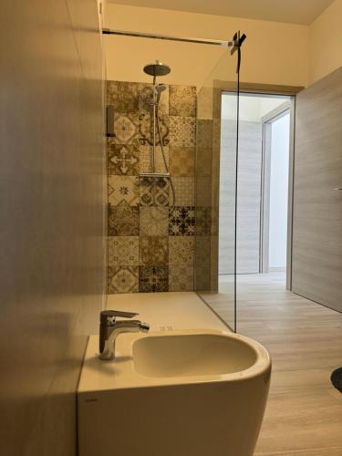 a bathroom with a sink and a shower at La Faustina Aosta in Aosta