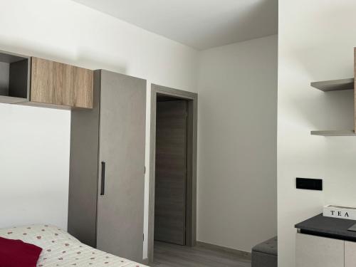 a bedroom with a bed and a wooden door at La Faustina Aosta in Aosta