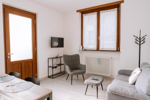 a living room with a couch and a chair at La Faustina Aosta in Aosta