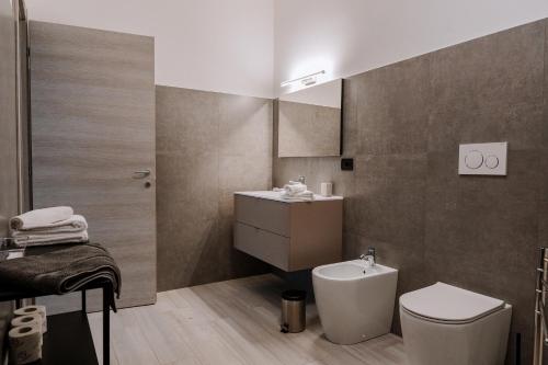 a bathroom with a toilet and a sink at La Faustina Aosta in Aosta