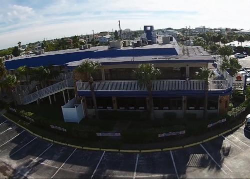 an aerial view of a building with palm trees in a parking lot at Inn on the Gulf in Hudson