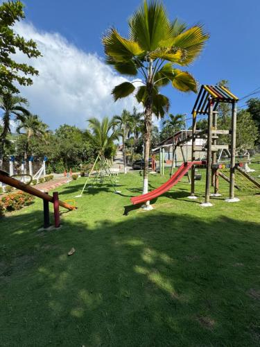 a park with a playground with a slide at Acogedora cabaña en la Pintada in La Pintada