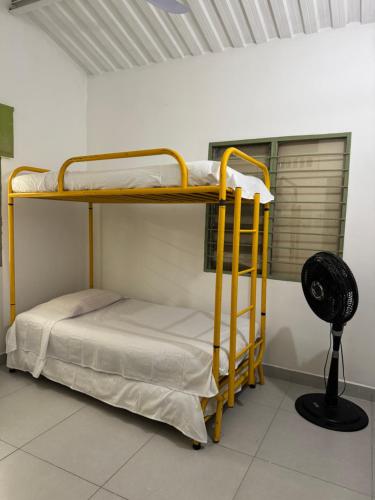 two bunk beds in a room with a fan at Acogedora cabaña en la Pintada in La Pintada