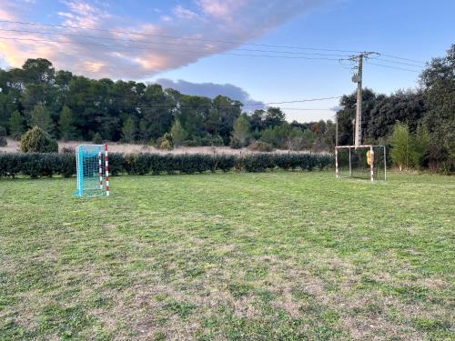 a field with two soccer goals in a field at terrain avec Mobil-Home in Sommières
