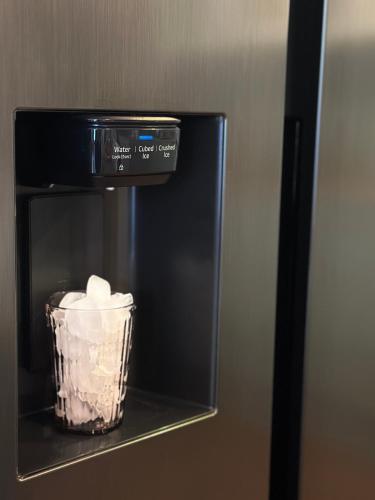 a black refrigerator with a container of marshmallows at Stadtwohnung mit Garten in Kassel