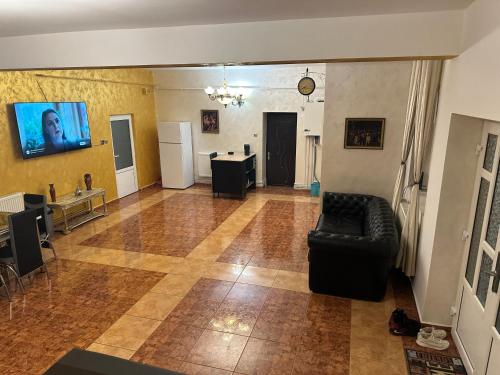 a living room with a couch and a table at Casa Bonita in Buşteni