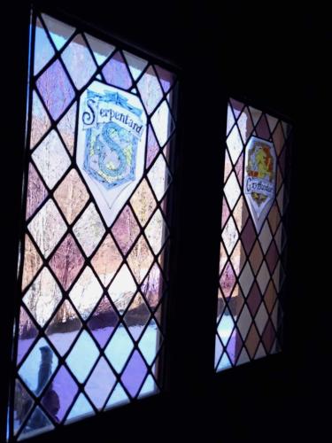 two stained glass windows with a crest on them at L'Entre 2 Cols in Saint-Martin-sur-le-Chambre