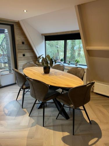 a dining room with a wooden table and chairs at Forest Lodge Durbuy in Durbuy