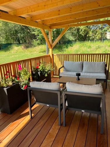 a wooden deck with two benches on a pergola at Domček pod Vežami s vírivkou a grilom, pri termálnom kúpalisku in Liptovský Ján