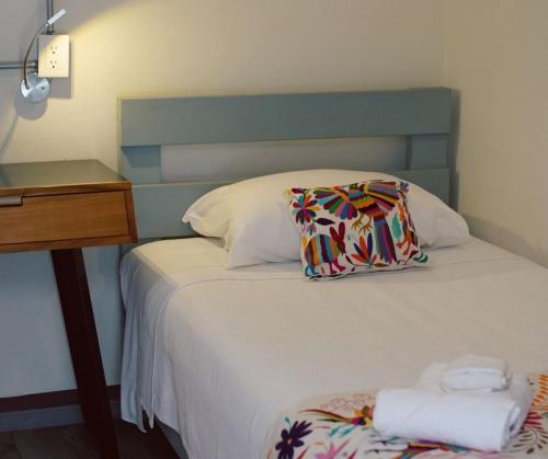 Postel nebo postele na pokoji v ubytování BKL Hotel Oaxaca