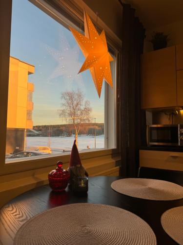 a dining room table with a star hanging from a window at Northern Lights River in Rovaniemi