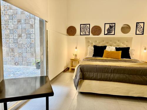 a bedroom with a bed and a table and a window at Studio Palermo Hollywood location! in Buenos Aires