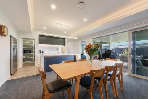a kitchen and dining room with a wooden table and chairs at 39Carmine Five Star 4-bedroom Holiday Home in Appleby