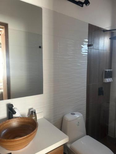a bathroom with a wooden sink and a toilet at Hotel Sol de la Montaña Villa de leyva in Villa de Leyva