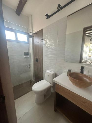 a bathroom with a toilet and a sink and a shower at Hotel Sol de la Montaña Villa de leyva in Villa de Leyva