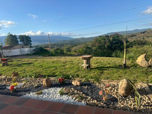 a garden with flowers and rocks in a field at Hotel Sol de la Montaña Villa de leyva in Villa de Leyva