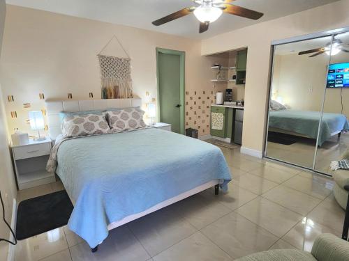 a bedroom with a large bed and a mirror at The Green Door Bungalow in Naples