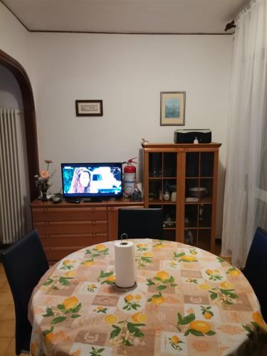 a dining room table with a table cloth with fruit on it at Camera in appartamento in Pordenone