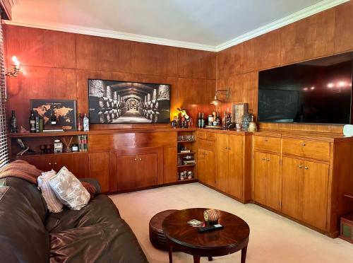 a living room with a couch and a tv at Ulmarra in Sussex inlet